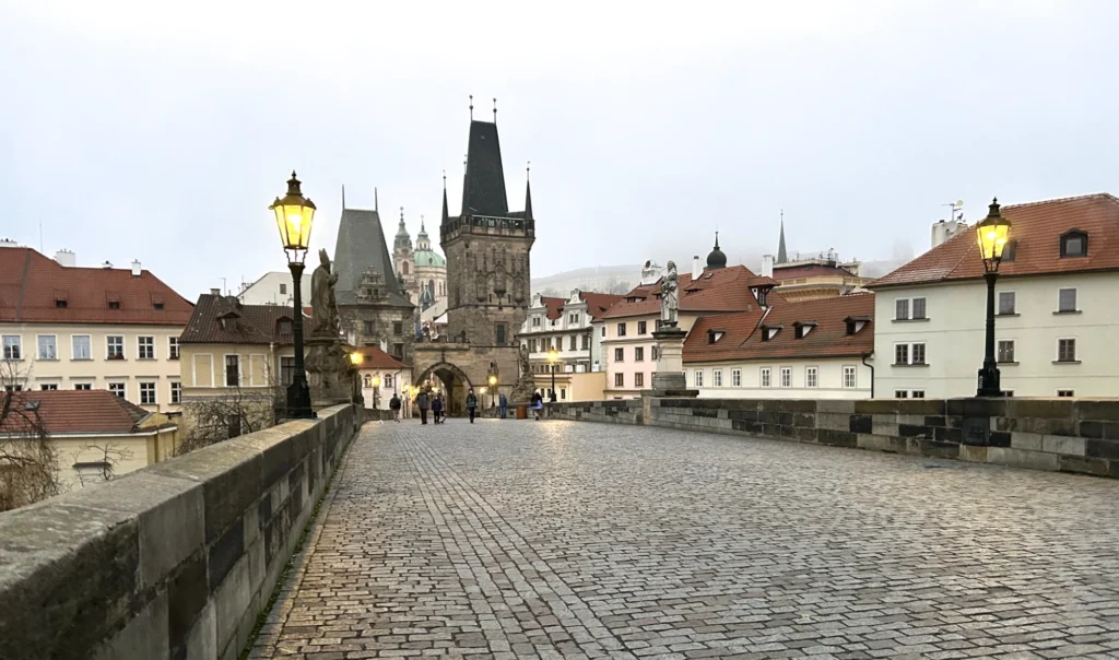 Charles Bridge in the early hours, lanterns lit